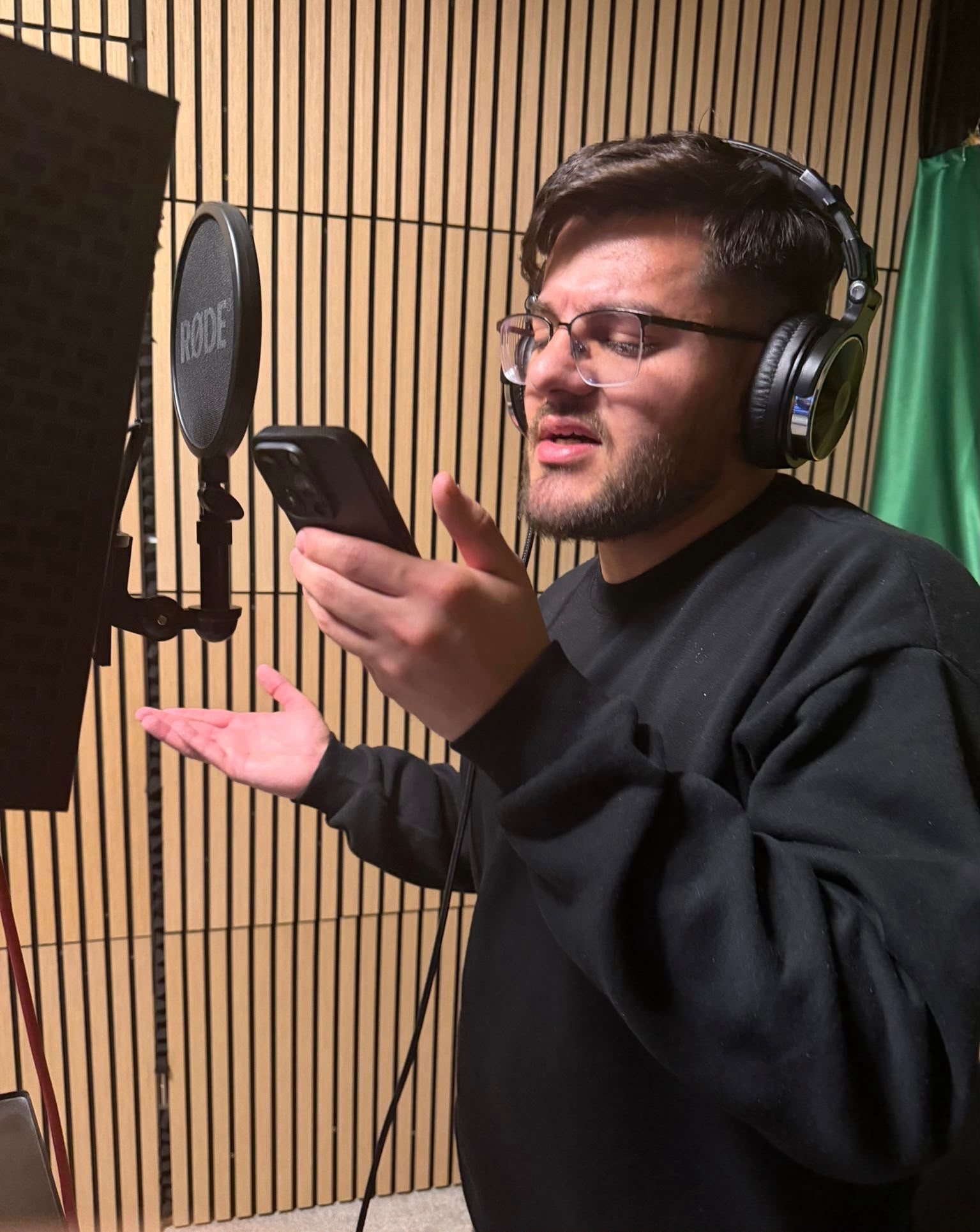 Artist recording vocals with headphones at Zeky Vocal Records in Germany