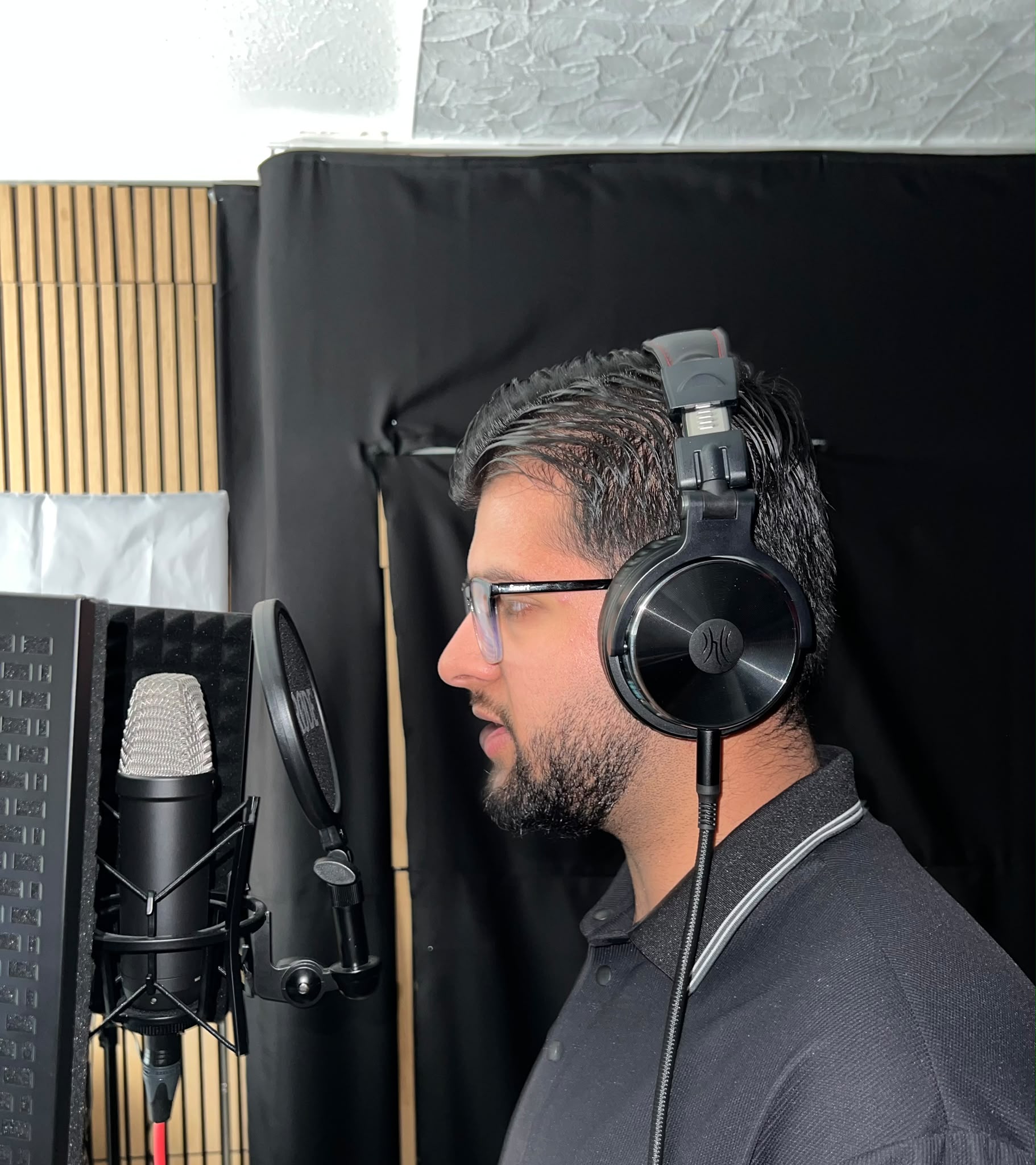 Vocalist performing at a studio microphone in Germany